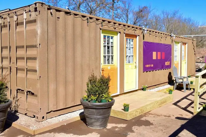 A brown shipping container with four doors
